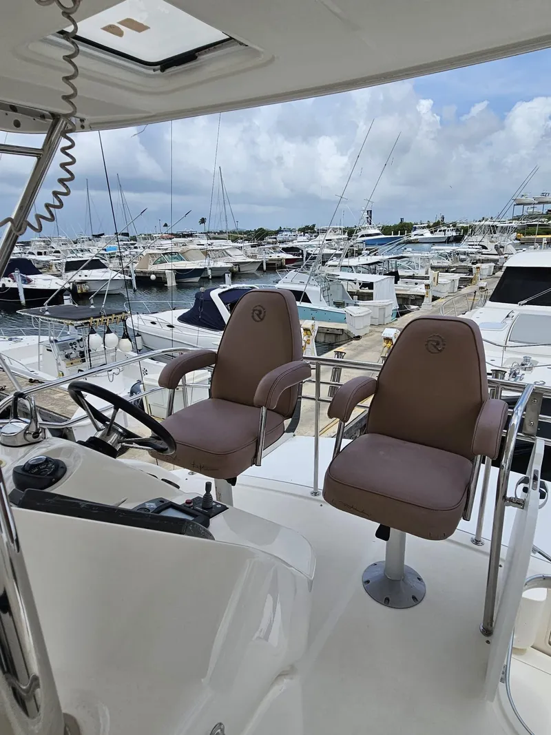Slide: The Image of 2007 Riviera 42 yacht helm with dual seats at marina. - 17