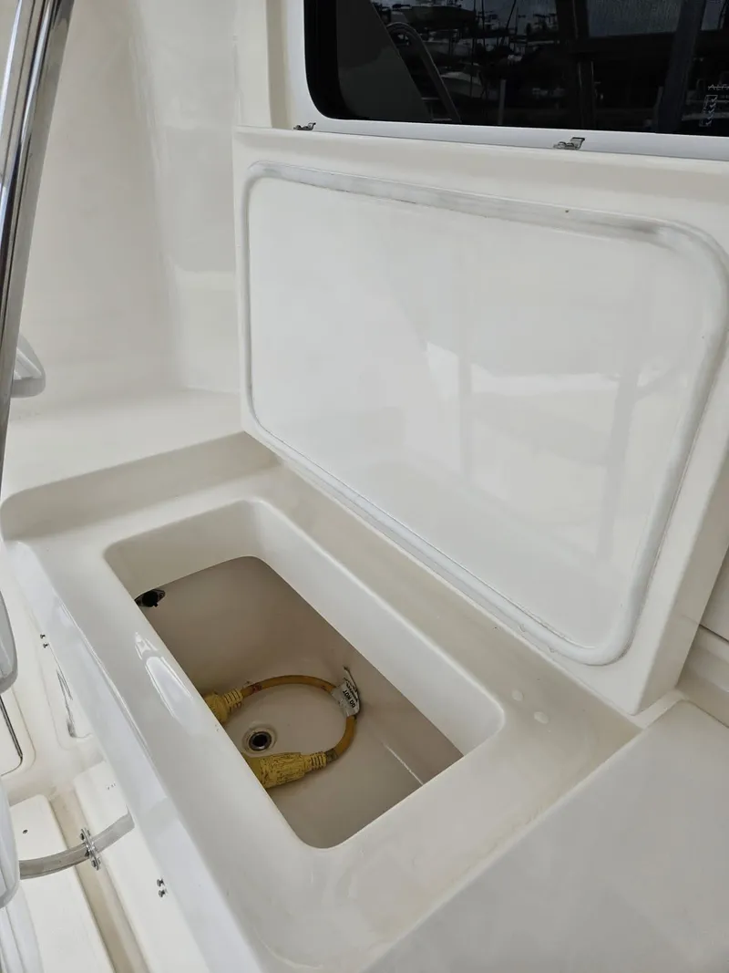 Slide: The Image of Riviera 42 2007 boat storage compartment with open lid, showcasing interior space. - 4