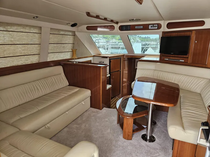 Slide: The Image of Luxurious interior of 2007 Riviera 42 yacht with plush seating and wooden accents. - 5