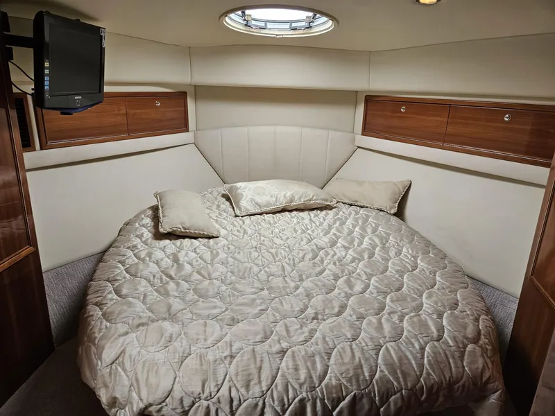 Slide: The Image of Luxurious bedroom interior of 2007 Riviera 42 yacht with cozy bedding and wooden accents. - 8