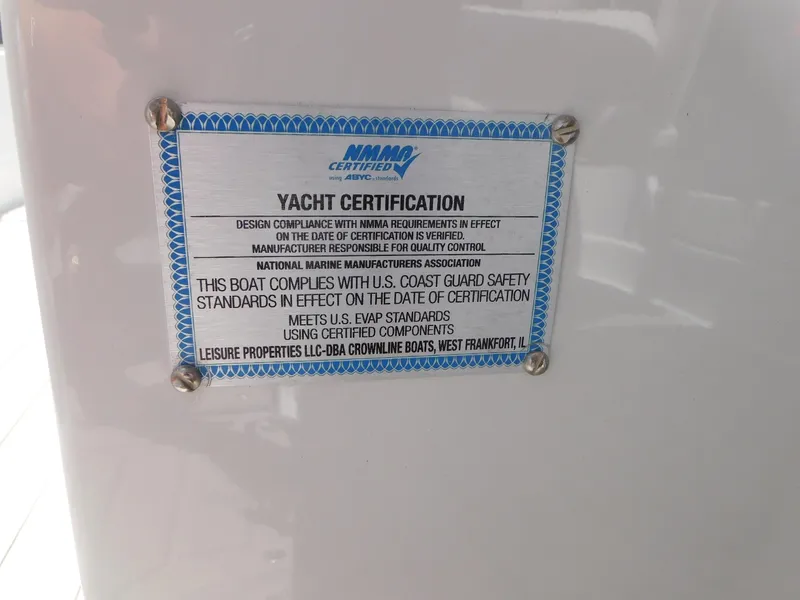 Slide: The Image of 2024 Crownline 280 SS boat with open cockpit and canopy in a storage area. - 12