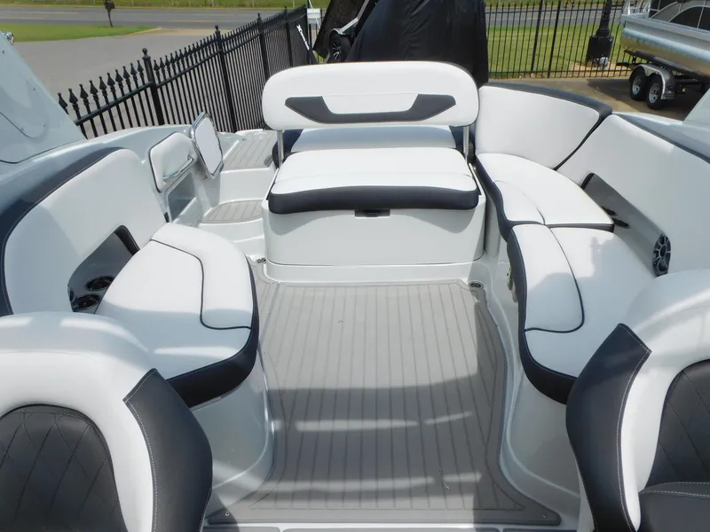 Slide: The Image of 2024 Crownline 280 SS boat interior with modern seating and blue ambient lighting. - 9