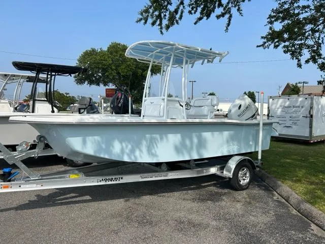 Slide: The Image of 2024 Savannah SS19 boat on a trailer in a parking lot. - 0