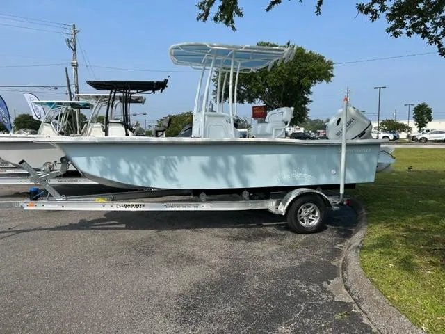 Slide: The Image of 2024 Savannah SS19 boat on trailer in outdoor display area. - 1