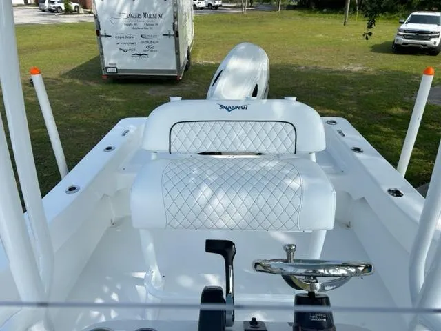 Slide: The Image of 2024 Savannah SS19 boat interior with white diamond-stitched seating and steering wheel. - 10