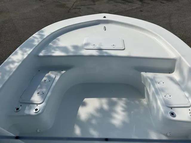 Slide: The Image of 2024 Savannah SS19 boat interior, white seating and storage compartments. - 11