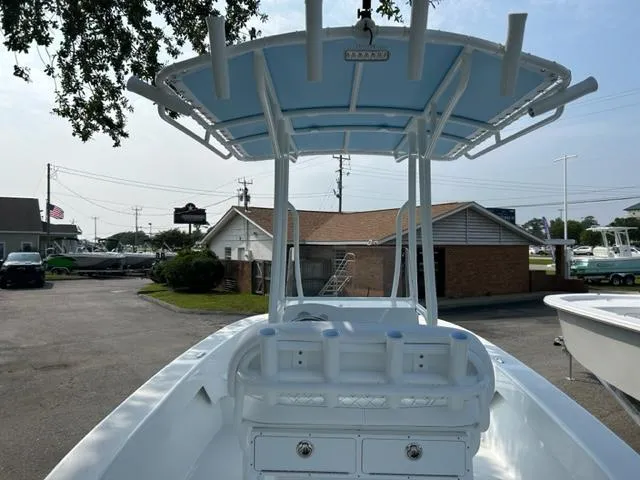 Slide: The Image of 2024 Savannah SS19 boat with T-top and rod holders in a marina. - 4