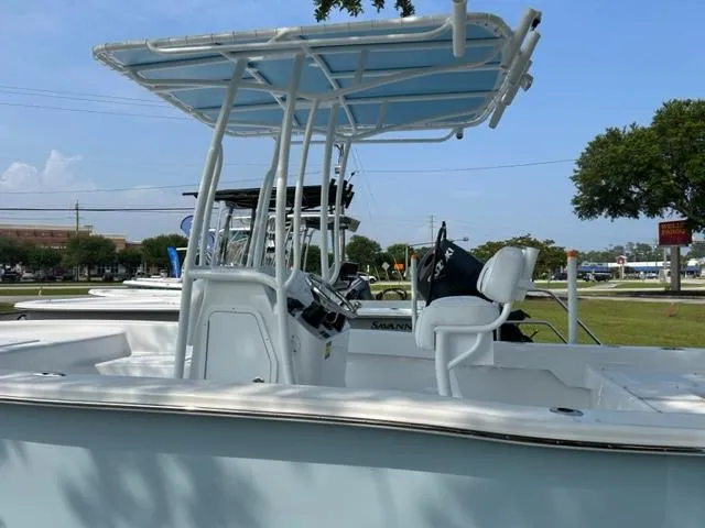 Slide: The Image of 2024 Savannah SS19 boat with T-top and center console in a marina. - 7