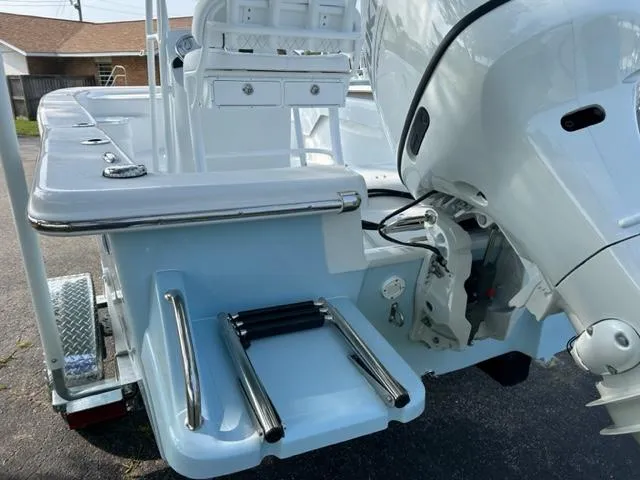 Slide: The Image of 2024 Savannah SS19 boat with outboard motor and swim ladder. - 5