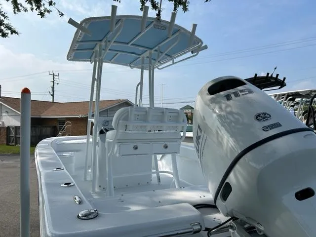 Slide: The Image of 2024 Savannah SS19 boat with 115 HP engine, white exterior, and T-top canopy. - 6