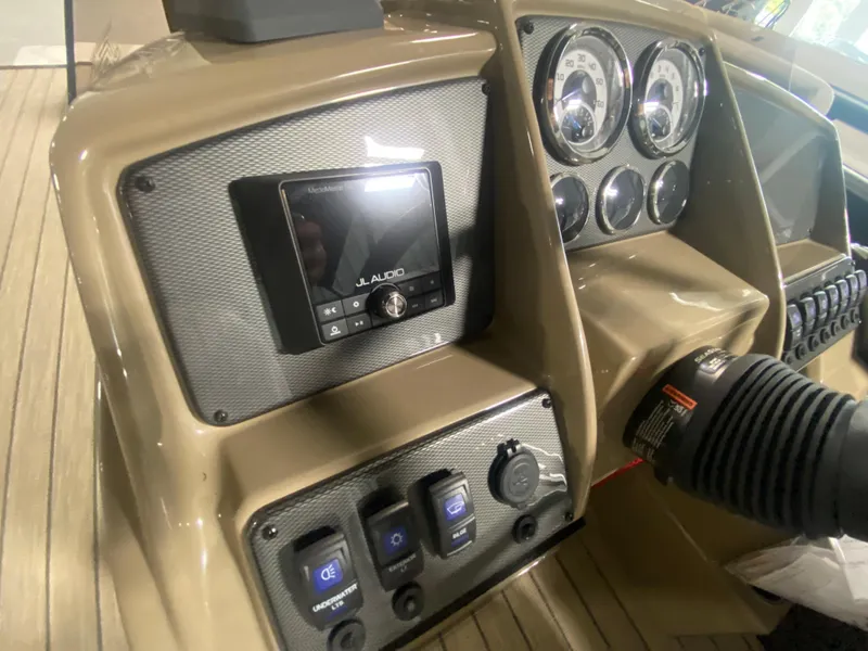 Slide: The Image of 2024 Starcraft EXS 1 boat dashboard with JL Audio system and control switches. - 11