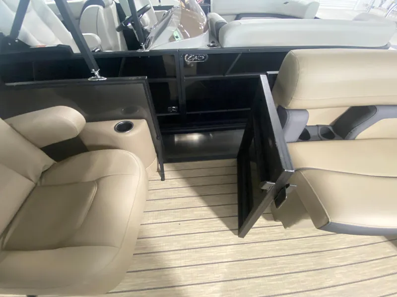 Slide: The Image of 2024 Starcraft EXS 1 boat interior with beige seating and wood flooring. - 13
