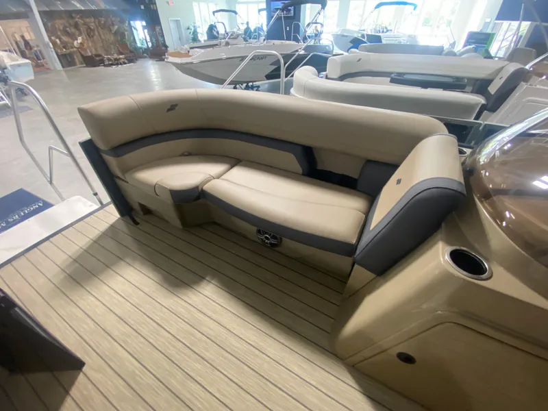 Slide: The Image of 2024 Starcraft EXS 1 boat interior with beige seating and wood flooring. - 15