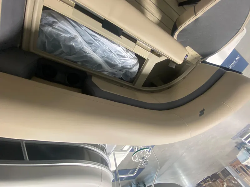 Slide: The Image of 2024 Starcraft EXS 1 boat interior with beige seating and storage compartments. - 16