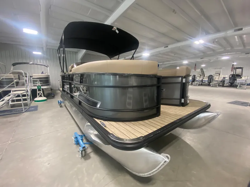 Slide: The Image of 2024 Starcraft EXS 1 pontoon boat in showroom, rear view. - 2