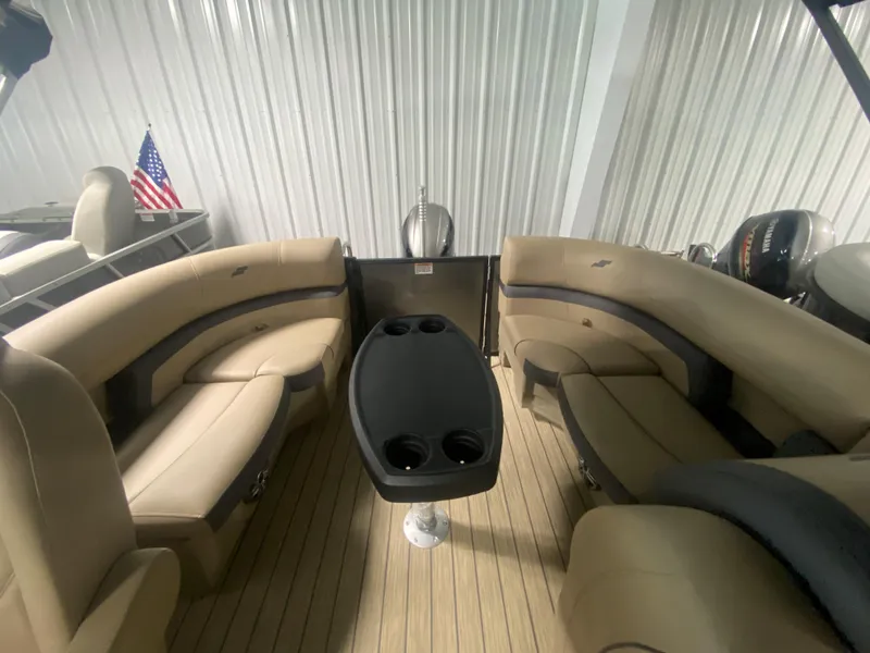 Slide: The Image of 2024 Starcraft EXS 1 boat interior with beige seating and a central table. - 21
