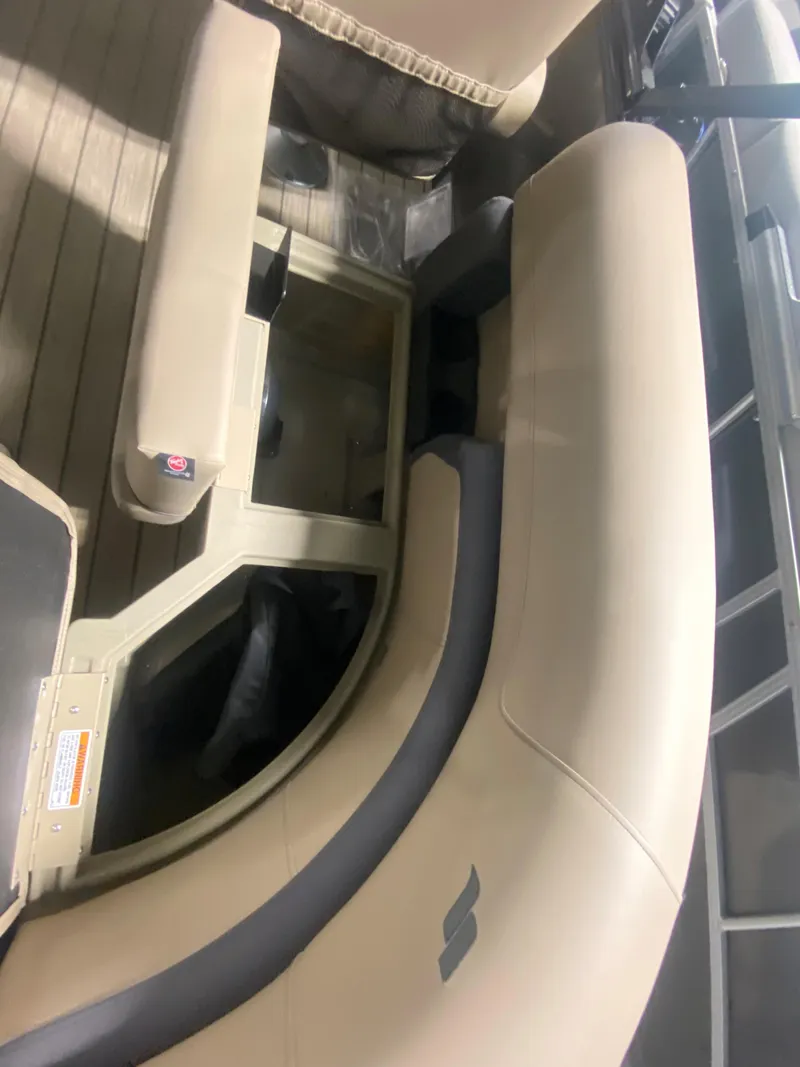 Slide: The Image of 2024 Starcraft EXS 1 boat interior with beige seating and storage compartments. - 8