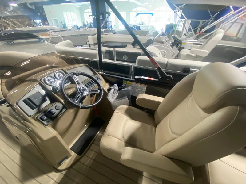 Slide: The Image of 2024 Starcraft EXS 1 boat interior with captain's chair and control panel. - 9