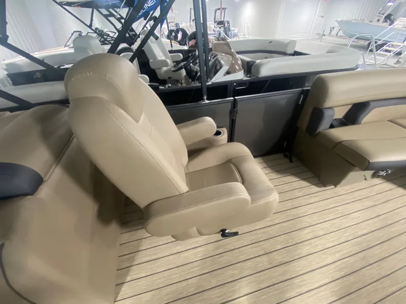 Slide: The Image of 2024 Starcraft EXS 1 boat interior with beige seating and steering console. - 12