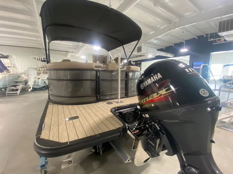 Slide: The Image of 2024 Starcraft EXS 1 pontoon boat with Yamaha outboard motor in showroom. - 3