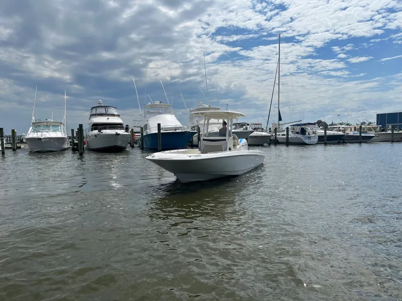Slide: The Image of 2020 Boston Whaler 270 Dauntless in a marina with other boats. - 2