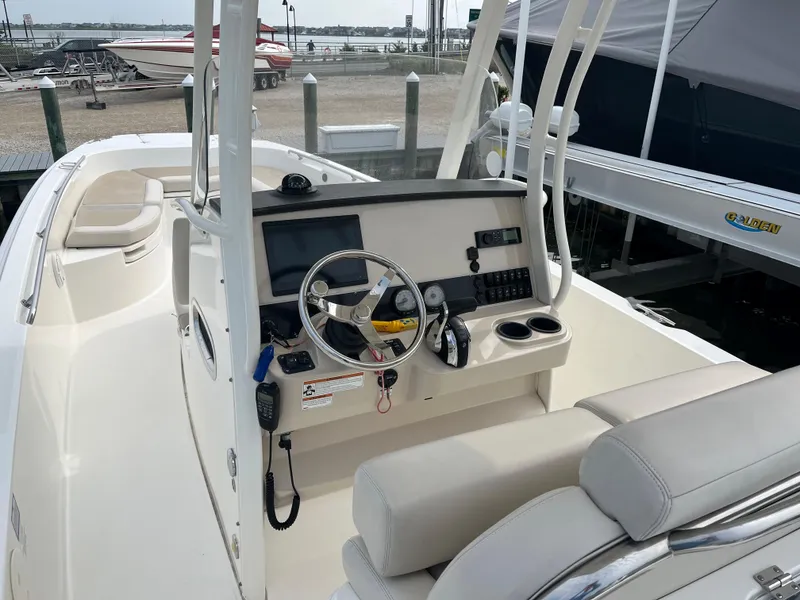 Slide: The Image of 2020 Boston Whaler 270 Dauntless boat interior with steering console and seating. - 6