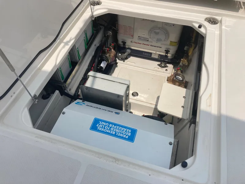 Slide: The Image of 2023 Pursuit DC 365 engine compartment with electrical components and battery system. - 14