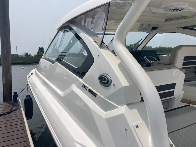 Slide: The Image of 2023 Pursuit DC 365 boat docked, showcasing sleek design and modern features. - 15