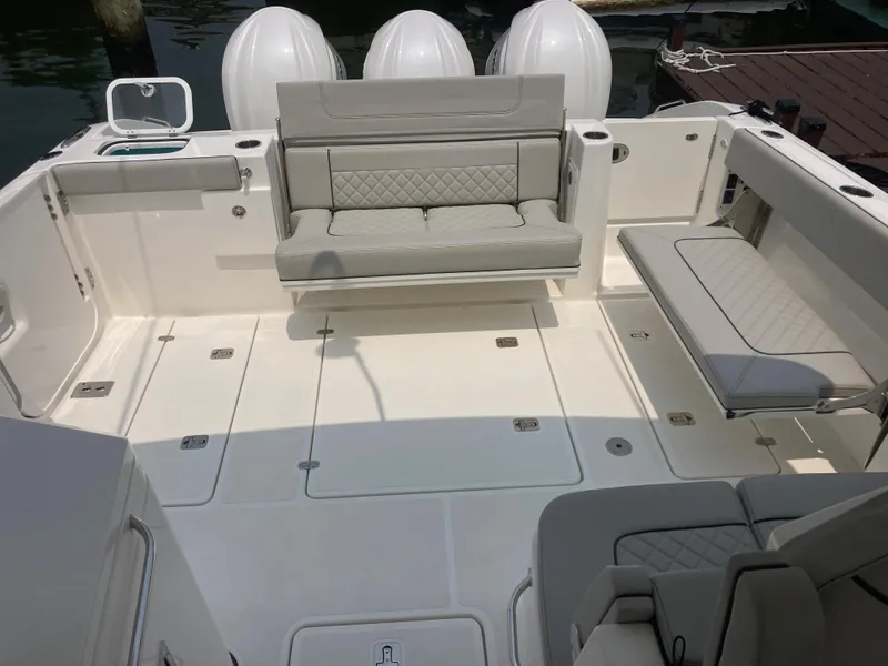 Slide: The Image of 2023 Pursuit DC 365 boat with spacious seating and clean deck layout. - 5