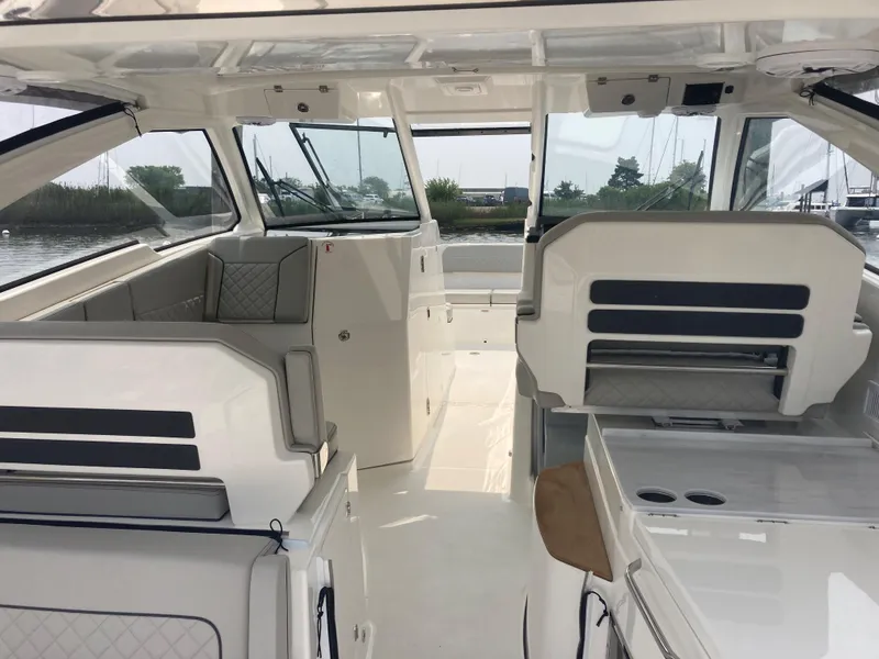 Slide: The Image of 2023 Pursuit DC 365 boat interior with seating and helm station. - 6