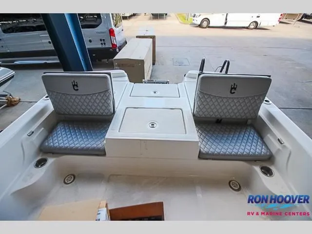Slide: The Image of 2023 Catalyst Boat Works 2300 BAY interior with quilted seating and storage compartments. - 10