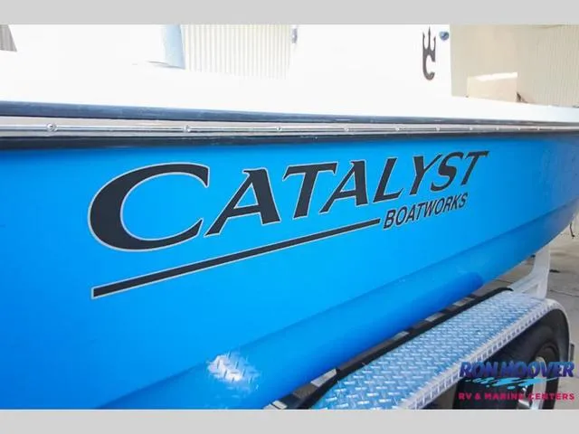 Slide: The Image of 2023 Catalyst Boat Works 2300 BAY, blue hull, side view. - 2