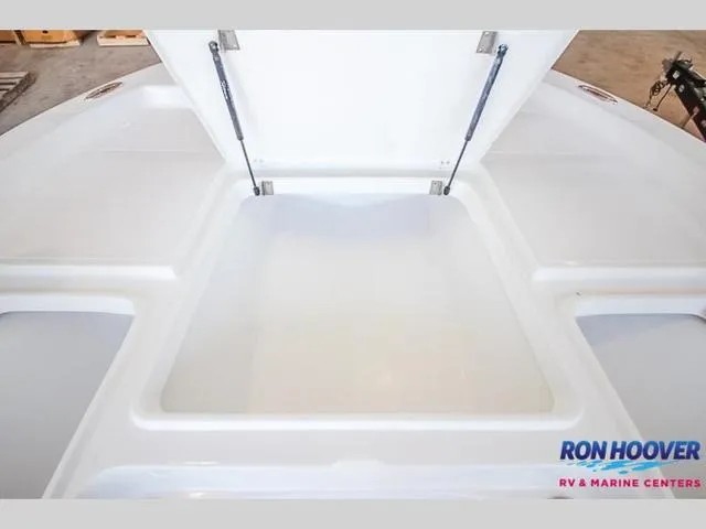 Slide: The Image of 2023 Catalyst Boat Works 2300 BAY storage compartment open, showcasing spacious interior. - 27