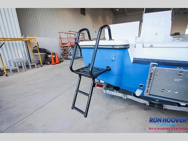 Slide: The Image of 2023 Catalyst Boat Works 2300 BAY with ladder in a showroom. - 6