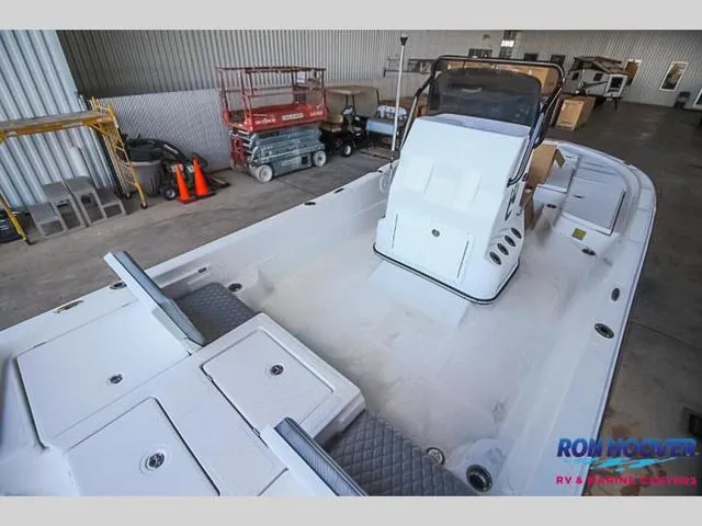 Slide: The Image of 2023 Catalyst Boat Works 2300 BAY in a warehouse setting, showcasing spacious deck and seating. - 7