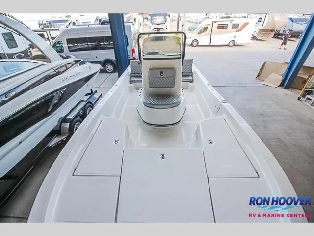 Slide: The Image of 2023 Catalyst Boat Works 2300 BAY in showroom, featuring spacious deck and modern design. - 9