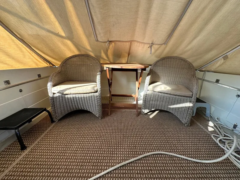 Slide: The Image of 1968 Chris-Craft 35 Commander interior with wicker chairs. - 24