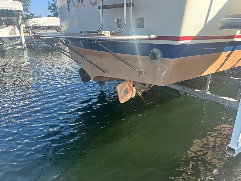 Slide: The Image of Stern of a 1968 Chris-Craft 35 Commander boat in water. - 27