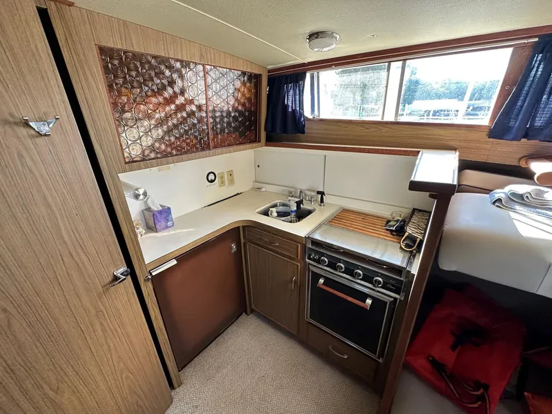 Slide: The Image of 1968 Chris-Craft 35 Commander interior with kitchen area. - 9