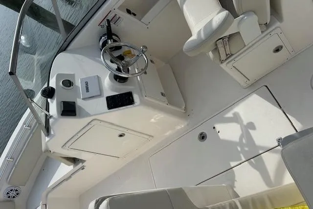 Slide: The Image of 2023 Scout 210 Dorado boat interior with steering wheel and seating. - 10