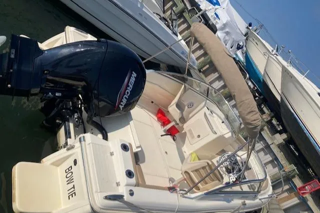 Slide: The Image of 2023 Scout 210 Dorado boat docked, featuring a Mercury outboard motor. - 4