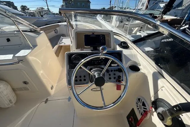 Slide: The Image of 2023 Scout 210 Dorado boat cockpit with steering wheel and control panel. - 6