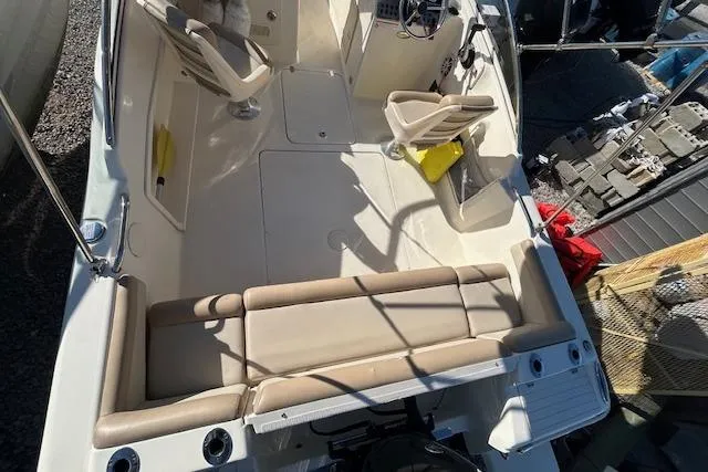 Slide: The Image of 2023 Scout 210 Dorado boat interior with seating and steering console. - 9