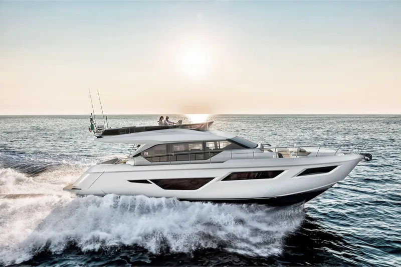 Slide: The Image of 2024 Ferretti Yachts 580 cruising on the ocean at sunset. - 0