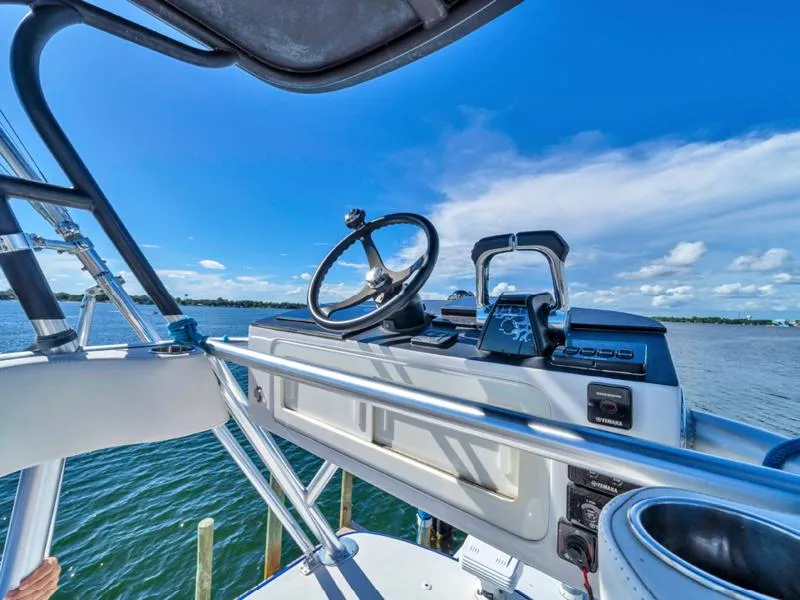 Slide: The Image of Helm of 2015 SeaHunter 45 boat with ocean view and clear blue sky. - 12