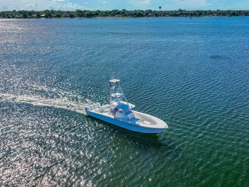 Slide: The Image of SeaHunter 45 boat cruising on open water, 2015 model, under clear blue sky. - 18