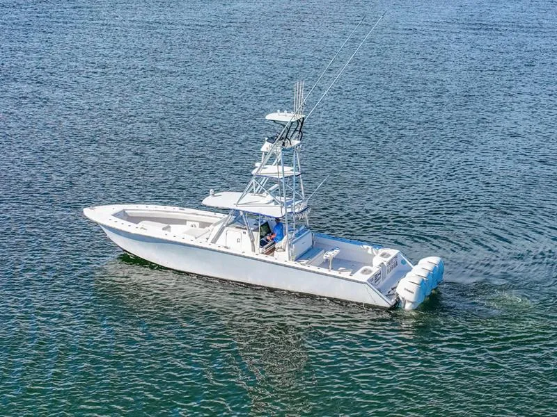 Slide: The Image of 2015 SeaHunter 45 boat cruising on open water, featuring multiple outboard engines. - 19