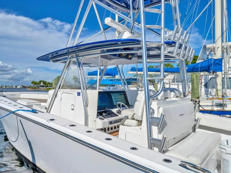 Slide: The Image of 2015 SeaHunter 45 boat with advanced navigation system and seating, docked at marina. - 4