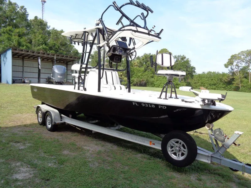 Slide: The Image of 2011 Cape Horn 23 Cape Bay boat on a trailer in a grassy area. - 0