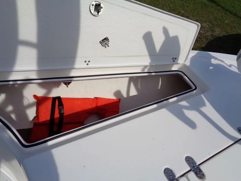 Slide: The Image of Open storage compartment on a 2011 Cape Horn 23 Cape Bay boat with an orange life jacket. - 24